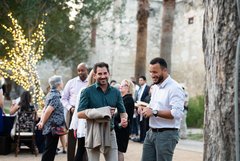 Two men enjoying an event in Alamo Gardens