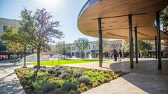 Corner of covered pavilion stage overlooking a large grass area