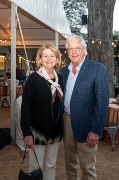 Woman and man standing outside a tent at an event
