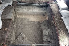 Dirt excavation area with pipes and rocks