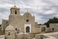 Stone mission with low barrack on two sides