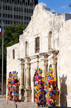 Front view of Alamo Church with Fiesta florals in front of entry columns