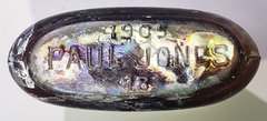 Base of historical liquor bottle that reads “1905 Paul Jones 18”