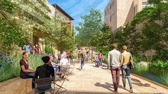People walking along a paved outdoor path next to a water feature