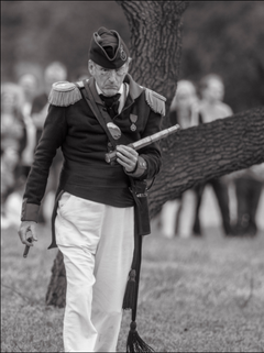 Living History volunteer holding a scope