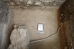 Tubelike caliche deposit across the inside of an excavation unit