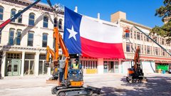 large texas flag over three story building