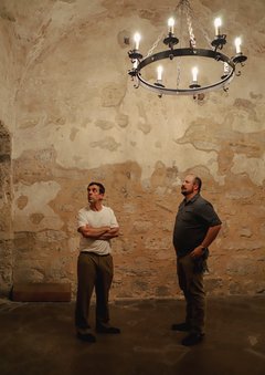 Two men inside the Sacristy in Alamo Church