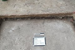 Sidewalk step below a step in an excavation unit