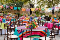 Tables set with colorful runners and centerpieces outdoors