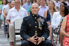 Decorated Marine General seated at his retirement ceremony