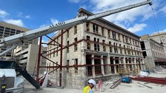 Corner of Crockett Building under construction with large Alamo crane