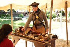 Living historians showing artifacts from the 1830s