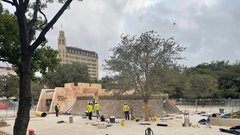 Construction workers outside of Lunette structure