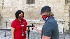 Visitor Services staff member scans a guest's ticket to enter Alamo Church