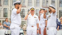 Group of four navy soliders saluting in Alamo Plaza