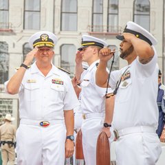 Group of four navy soliders saluting in Alamo Plaza