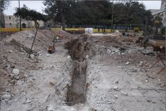 Excavation area next to Alamo Plaza with a long, narrow dug out area