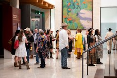 Crowd of guests exploring gallery at an event