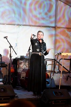Kate Rogers standing on speech giving remarks at an event
