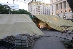 Two tarp coverings over the Long Barrack excavation area