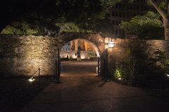 Arched entry to Cavalry Courtyard lit up at night