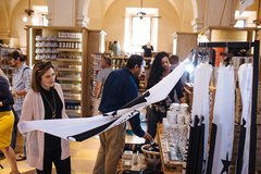 Woman looking at a Come and Take It flag in the Alamo Gift Shop