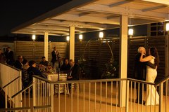 Bride dancing with father while seated guests watch