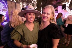 Two women in Alamo Gardens at night