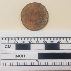 Coin that says Confederation Helvetica 1882 next to a ruler