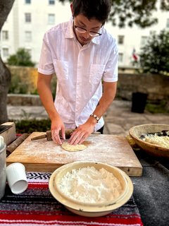 Man preparing tortillas on a cutting board covered in flour