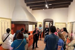 A group of teachers in a lobby area listing to a guide speak