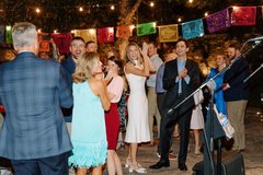 Guests standing and applauding on an outdoor dance floor