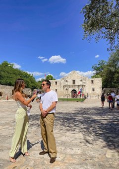 A woman interviews a man in Alamo Plaza