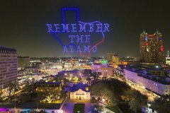 Texas Shape with words Remember the Alamo in drone lights over Alamo Church at night