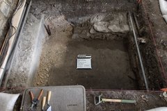 Excavation unit with a small white board in the center bordered with tools