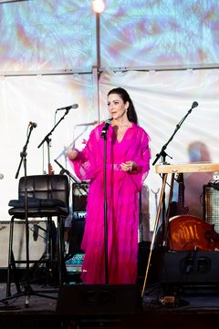 Shannon Ralston standing on stage giving remarks at an event