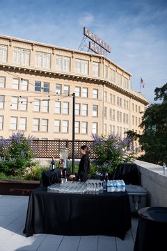 Table set up as a bar with a black linen, Crockett Hotel in the background