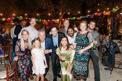 Large group of guests gathered and smiling at the camera