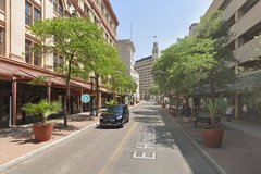 View of Houston Street lined with trees and buildings