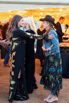 Two women greeting one another at an event
