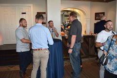 Guests around a cocktail table inside La Vista Terrace penthouse