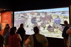 Teachers looking at a map of buildings on a large screen