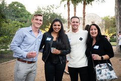 Four guests smiling at an event in Alamo Gardens
