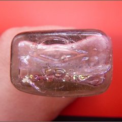 Close up view of base of glass bottle recovered from excavation unit