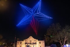 Texas Lone Star in drone lights over Alamo Church at night