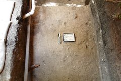 Bumpy dirt surface with a pipe in an excavation unit