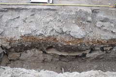 Long, narrow hollowed out area in excavation plot