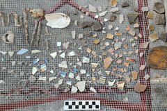 Ceramic fragments in different shapes and colors on a fenced background