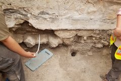 Excavation unit with a few stones missing from the foundation